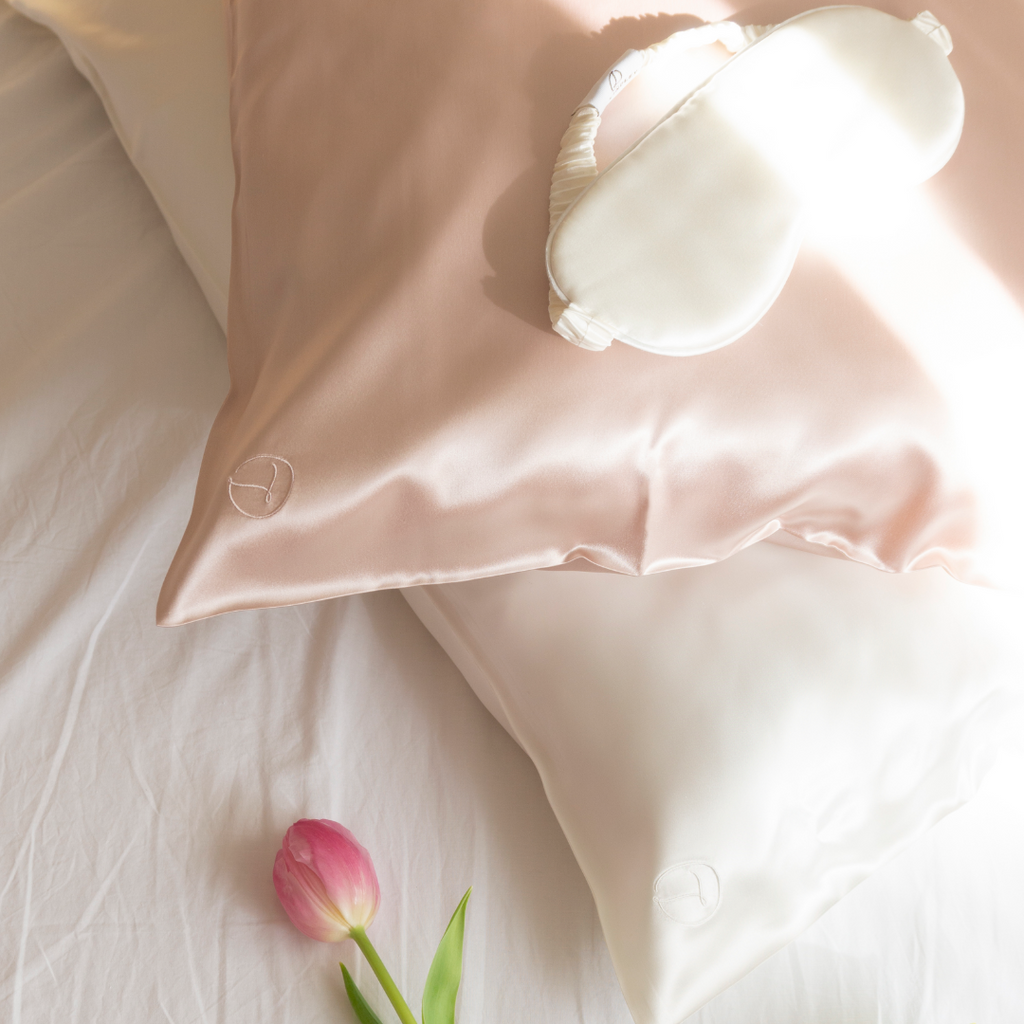 Spring light on silk pillowcase and eye mask. Spring tulips